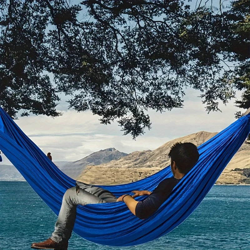 Lightweight camping hammock set up between trees