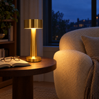 Rechargeable table lamp lighting a reading corner beside a boucle armchair