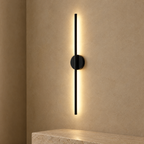 Black magnetic wall light on a sand plaster wall